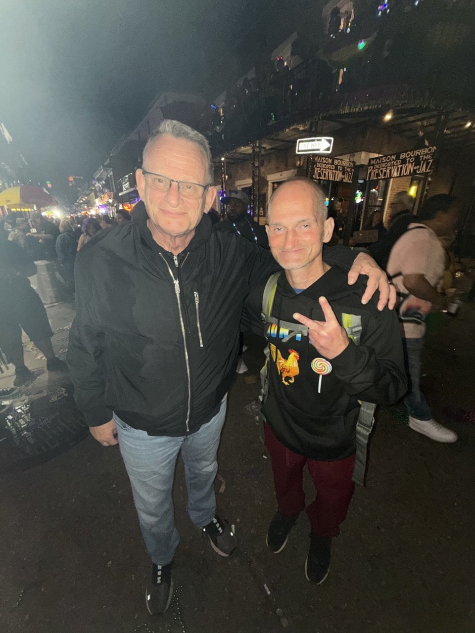 Two men posing at night on Bourbon St